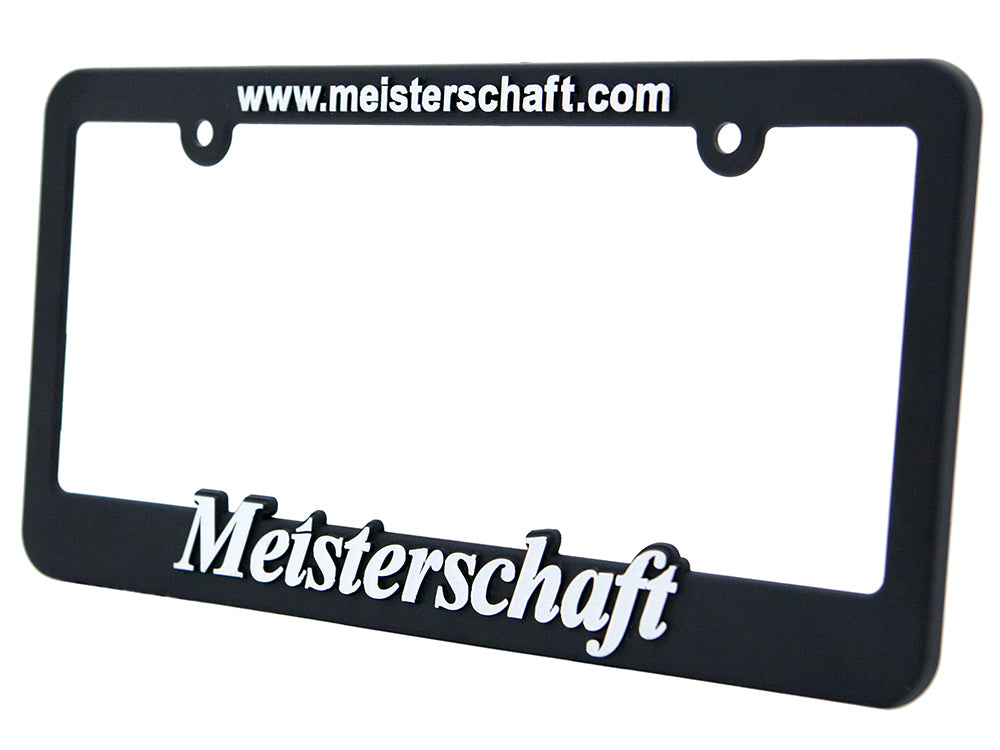 Meisterschaft license frame in black with white lettering, featuring the brand name and website.