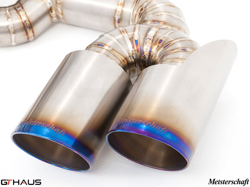 Close-up of a Meisterschaft exhaust tip featuring polished stainless steel with a blue-tinted finish, designed for Ferrari F430.