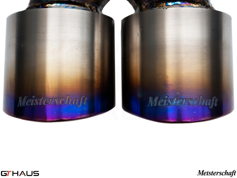 Close-up of Meisterschaft exhaust tips for Porsche 987 Cayman/S, showcasing a polished finish and vibrant color gradient.