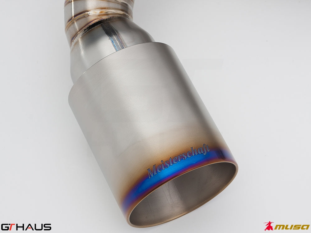 Meisterschaft exhaust tip for Nissan 370Z Nismo Edition, showcasing polished stainless steel with a blue gradient finish.