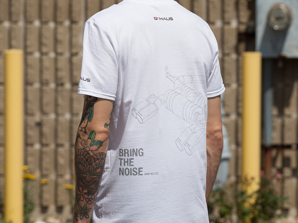 White MEISTERSCHAFT T-shirt featuring a BMW M3 exhaust design and "BRING THE NOISE" text on the back.