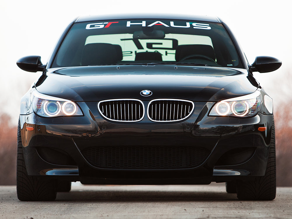 GTHAUS decal on a black BMW's front windshield, showcasing brand identity and performance focus.