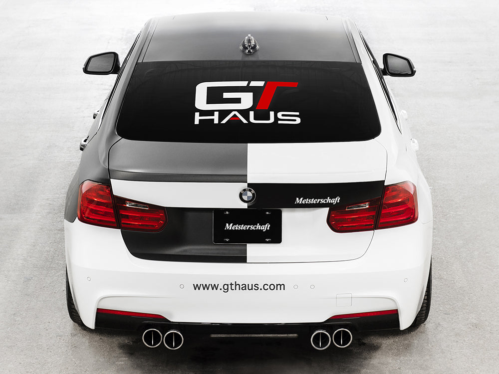 GTHAUS decal on a rear windshield of a BMW, featuring a bold logo and sleek design for automotive enthusiasts.