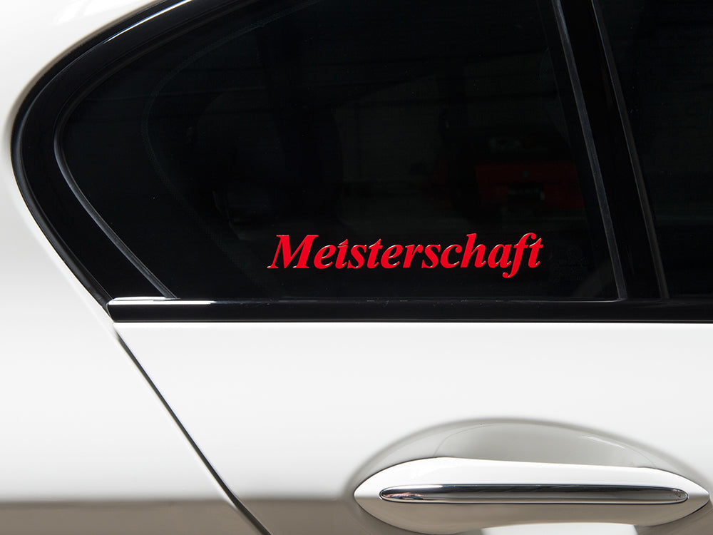 Meisterschaft decal in red on a car window, featuring a transparent background, sold in a set of two pieces.