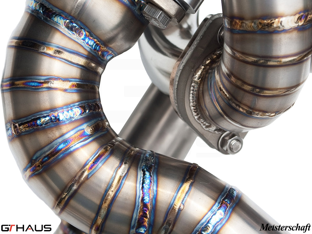 Close-up of a high-performance exhaust system featuring precision welding and stainless steel construction, designed for Ferrari F430 Scuderia.