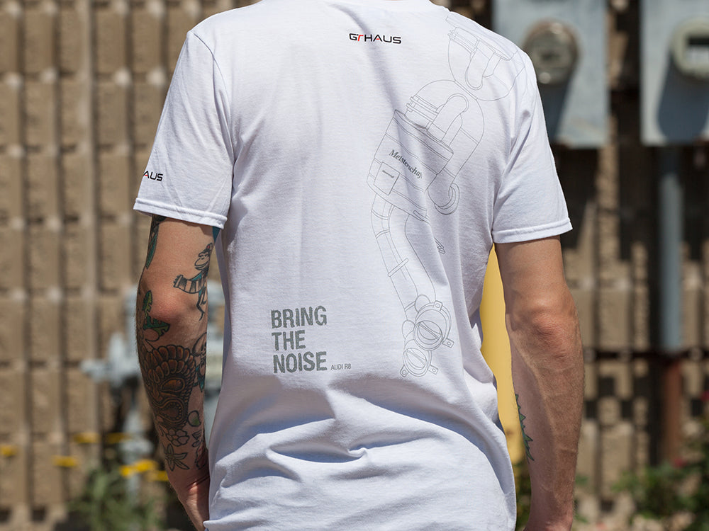 White MEISTERSCHAFT T-shirt featuring an Audi R8 exhaust design and "Bring the Noise" text on the back.