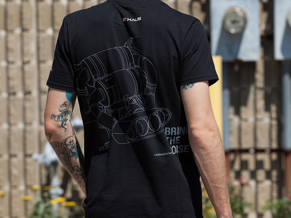 Black MEISTERSCHAFT T-shirt featuring a graphic of a Lamborghini Aventador exhaust system design.